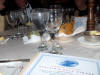 Picture of dinner table with lots of glassware